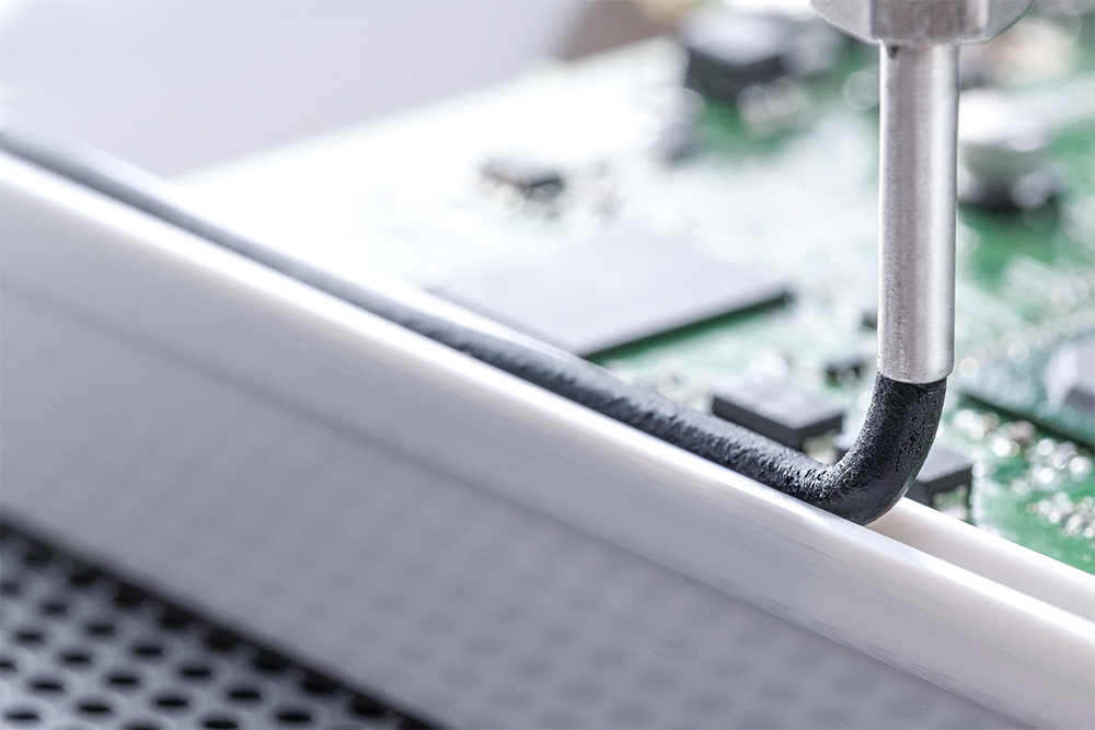 A Wevo sealant being applied to a component housing.